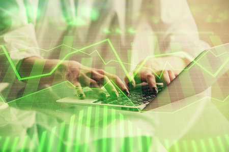 Double exposure of woman hands typing on computer and forex chart hologram drawing. Stock market invest concept.の写真素材
