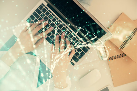 Double exposure of woman hands working on computer and DNA hologram drawing. Top View. Medical education concept.の写真素材