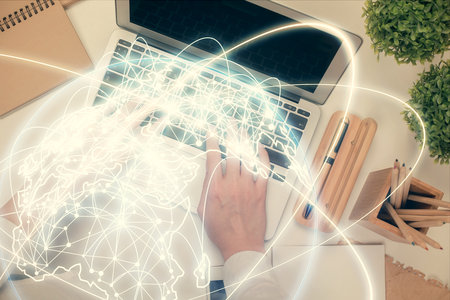 Double exposure of woman hands working on computer and financial theme hologram drawing. Top View. Business concept.の写真素材