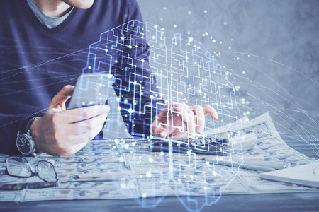 Double exposure of man's hand holding and using a digital device and brain hologram drawing. Data concept.の写真素材