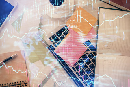 Multi exposure of financial chart drawing over table background with computer. Concept of research and analysis. Top view.の写真素材