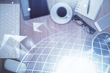 Double exposure of map hologram drawing over desktop. Top view. International connection concept.の写真素材