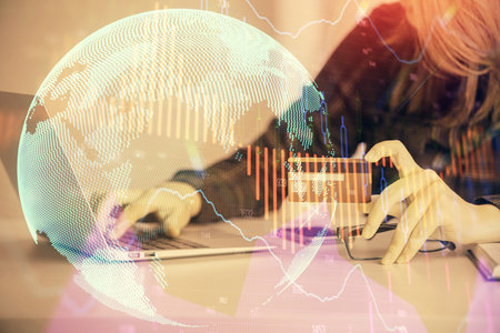 Double exposure of woman on-line shopping holding a credit card and financial graph drawing. Stock market E-commerce concept.の写真素材