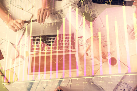 Double exposure of man and woman working together and financial graph hologram. Business concept....