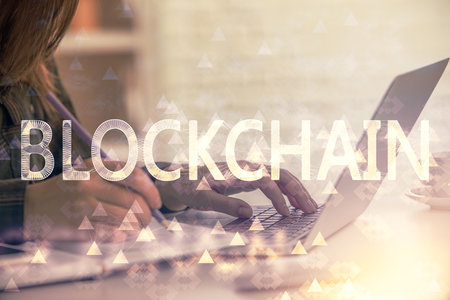 Double exposure of woman hands typing on computer and crypto market theme hologram drawing. Blockchain concept.の写真素材