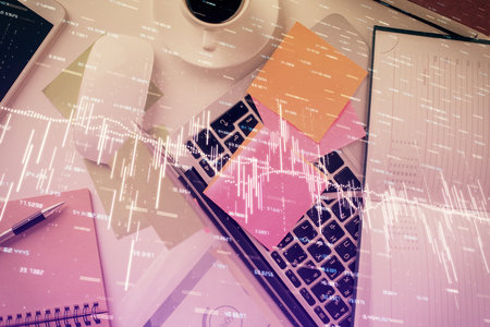 Multi exposure of financial chart drawing over table background with computer. Concept of research and analysis. Top view.の写真素材