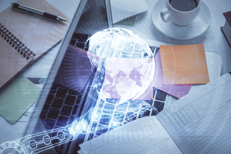 Double exposure of map hologram drawing over study table background with computer. Concept of international network. Top view.の写真素材