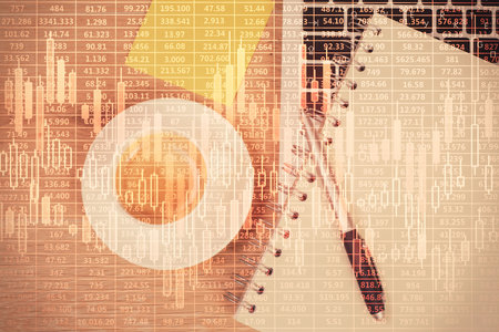Double exposure of financial chart drawing over table background with computer. Concept of research and analysis. Top view.の写真素材