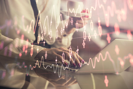 Double exposure of businesswoman hands typing on computer and financial graph hologram drawing. Stock market analysis concept.の写真素材