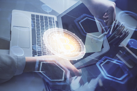 Double exposure of woman hands typing on computer and crypto market theme hologram drawing....