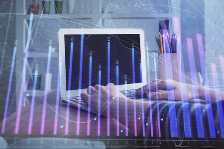 Double exposure of woman hands typing on computer and forex chart hologram drawing. Stock market invest concept.の写真素材