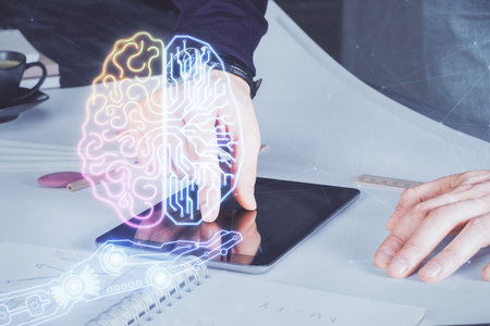 Double exposure of man's hand holding and using a digital device and brain hologram drawing. Data concept.の写真素材