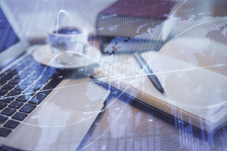 Double exposure of forex chart drawing and desktop with coffee and items on table background. Concept of financial market tradingの写真素材