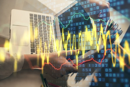 Double exposure of businesswoman hands typing on computer and financial graph hologram drawing. Stock market analysis concept.の写真素材