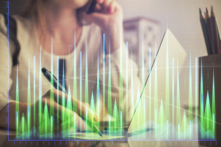 Double exposure of woman hands typing on computer and financial graph hologram drawing. Stock market analysis concept.の写真素材