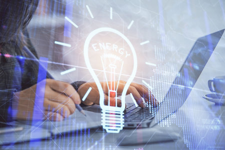 Double exposure of woman hands typing on computer and light bulb drawing. Idea concept.の写真素材