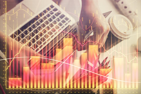 Double exposure of businesswoman hands typing on computer and financial graph hologram drawing. Stock market analysis concept.の写真素材