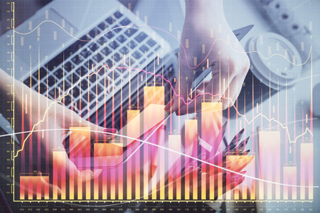 Double exposure of businesswoman hands typing on computer and financial graph hologram drawing. Stock market analysis concept.の写真素材