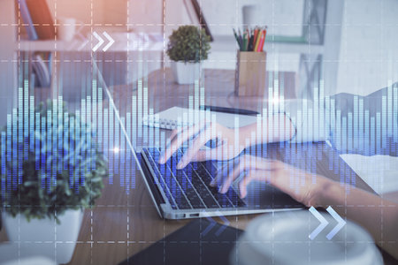 Double exposure of woman hands typing on computer and forex chart hologram drawing. Stock market invest concept.の写真素材