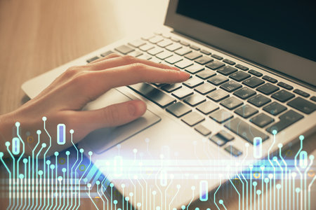 Double exposure of woman hands working on computer and data theme hologram drawing. Tech concept.の写真素材