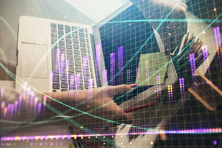Double exposure of businesswoman hands typing on computer and financial graph hologram drawing. Stock market analysis concept.の写真素材