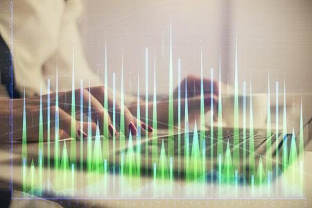 Multi exposure of woman hands typing on computer and financial graph hologram drawing. Stock market analysis concept.の写真素材