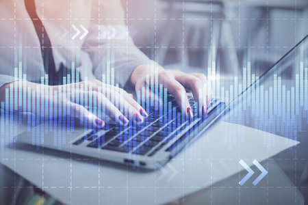 Multi exposure of woman hands typing on computer and financial graph hologram drawing. Stock market analysis concept.の写真素材