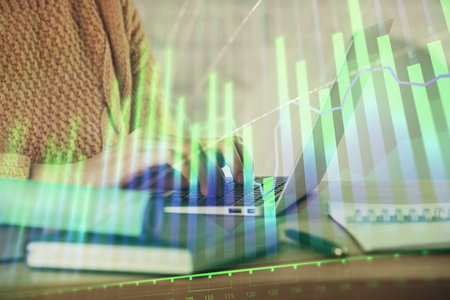 Double exposure of woman hands typing on computer and forex chart hologram drawing. Stock market analysis concept.の写真素材