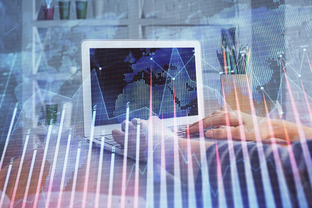 Double exposure of woman hands typing on computer and forex chart hologram drawing. Stock market invest concept.の写真素材