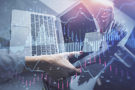 Double exposure of businesswoman hands typing on computer and financial graph hologram drawing. Stock market analysis concept.の写真素材