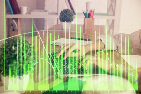 Double exposure of woman hands typing on computer and forex chart hologram drawing. Stock market invest concept.の写真素材