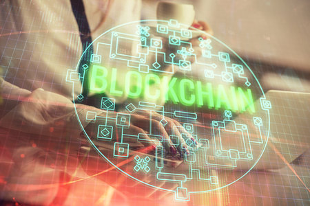 Double exposure of woman hands typing on computer and crypto market theme hologram drawing. Blockchain concept.の写真素材