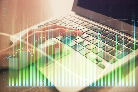 Double exposure of woman hands typing on computer and forex chart hologram drawing. Stock market analysis concept.の写真素材