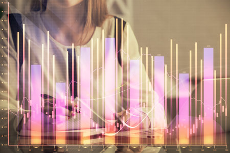 Double exposure of businesswoman hands typing on computer and financial graph hologram drawing. Stock market analysis concept.の写真素材