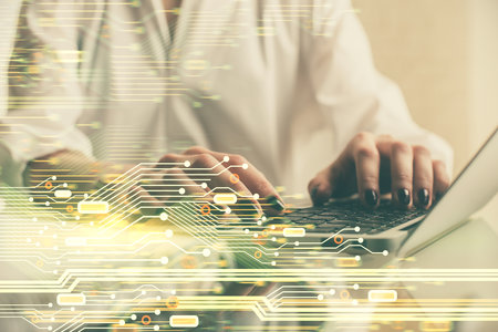 Double exposure of woman hands working on computer and data theme hologram drawing. Tech concept.の写真素材