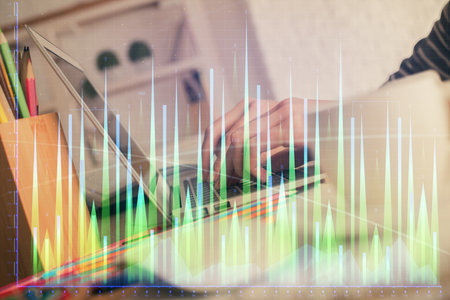Double exposure of woman hands typing on computer and forex chart hologram drawing. Stock market invest concept.の写真素材