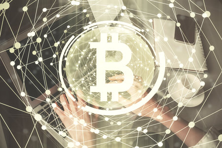 Double exposure of woman hands typing on computer and crypto market theme hologram drawing. Blockchain concept.の写真素材