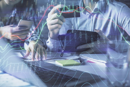 Double exposure of man and woman on-line shopping holding a credit card and forex graph hologram drawing. Stock market E-commerce pay on-line concept.の写真素材