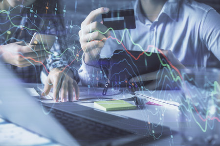 Double exposure of man and woman on-line shopping holding a credit card and forex graph hologram drawing. Stock market E-commerce pay on-line concept.の写真素材