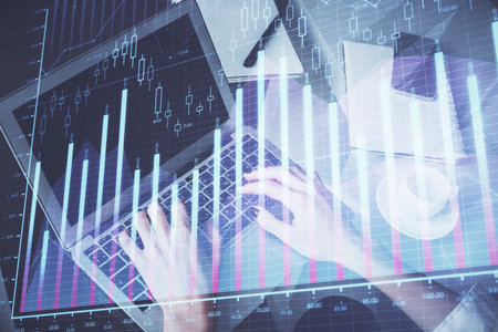 Double exposure of woman hands typing on computer and forex chart hologram drawing. Stock market invest concept.の写真素材