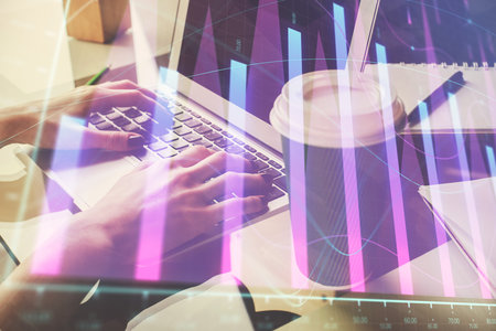 Double exposure of woman hands typing on computer and forex chart hologram drawing. Stock market invest concept.の写真素材