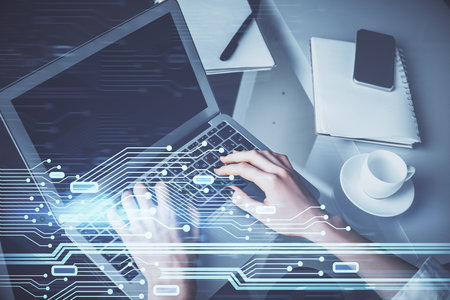 Double exposure of woman hands working on computer and data theme hologram drawing. Tech concept.の写真素材