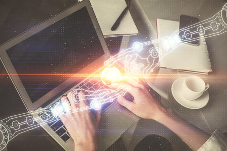Double exposure of woman hands working on computer and data theme hologram drawing. Tech concept.の写真素材