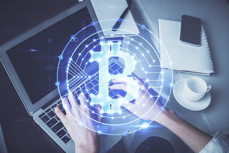 Double exposure of woman hands typing on computer and crypto market theme hologram drawing. Blockchain concept.の写真素材