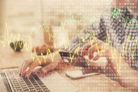 Double exposure of man hands holding a credit card and Forex graph drawing. Stock trading and digital fintech in Internet E-commerce concept.の写真素材
