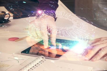 Double exposure of man's hand holding and using a digital device and data theme drawing. Technology concept.の写真素材