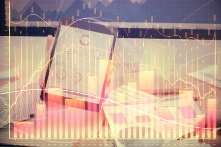 Double exposure of man's hands holding and using a digital device and forex graph drawing. Financial market concept.の写真素材