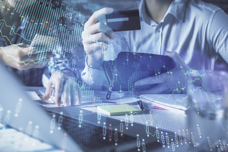 Double exposure of man and woman on-line shopping holding a credit card and forex graph hologram drawing. Stock market E-commerce pay on-line concept.の写真素材