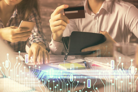 Double exposure of man and woman on-line shopping holding a credit card and data theme hologram drawing. Ai and E-commerce pay on-line concept.の写真素材