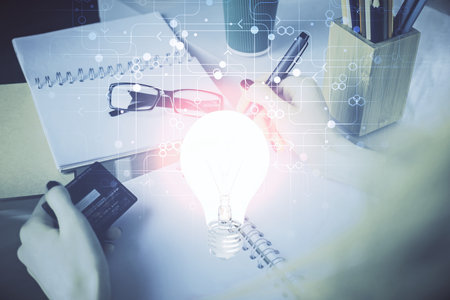 Multi exposure of woman on-line shopping holding a credit card and bulb drawing. Choice concept.の写真素材